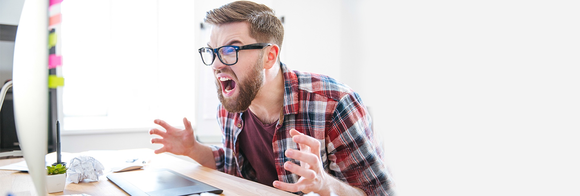 Facebook Zero – Everything you need to know! man screaming at his computer in frustration to Facebook zero
